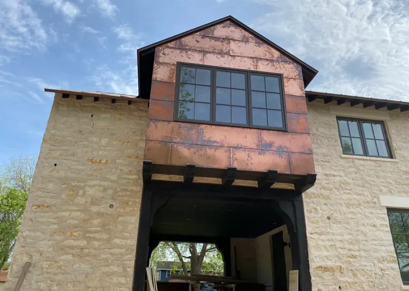 Copper metal panel facade on a stone building for Roof Repair in Harrisonburg